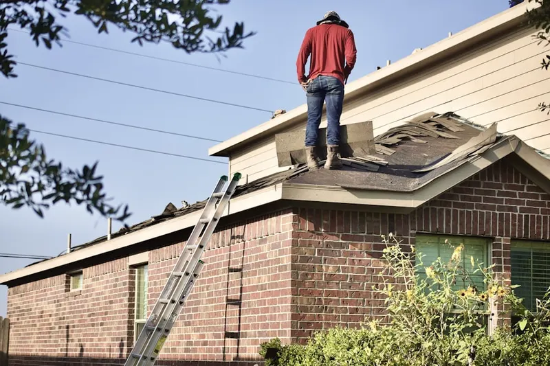 Professional roofer working on a residential roof in Atchison